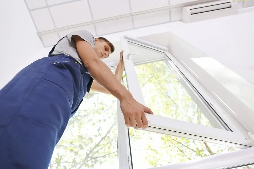 Image of a man doing a window install