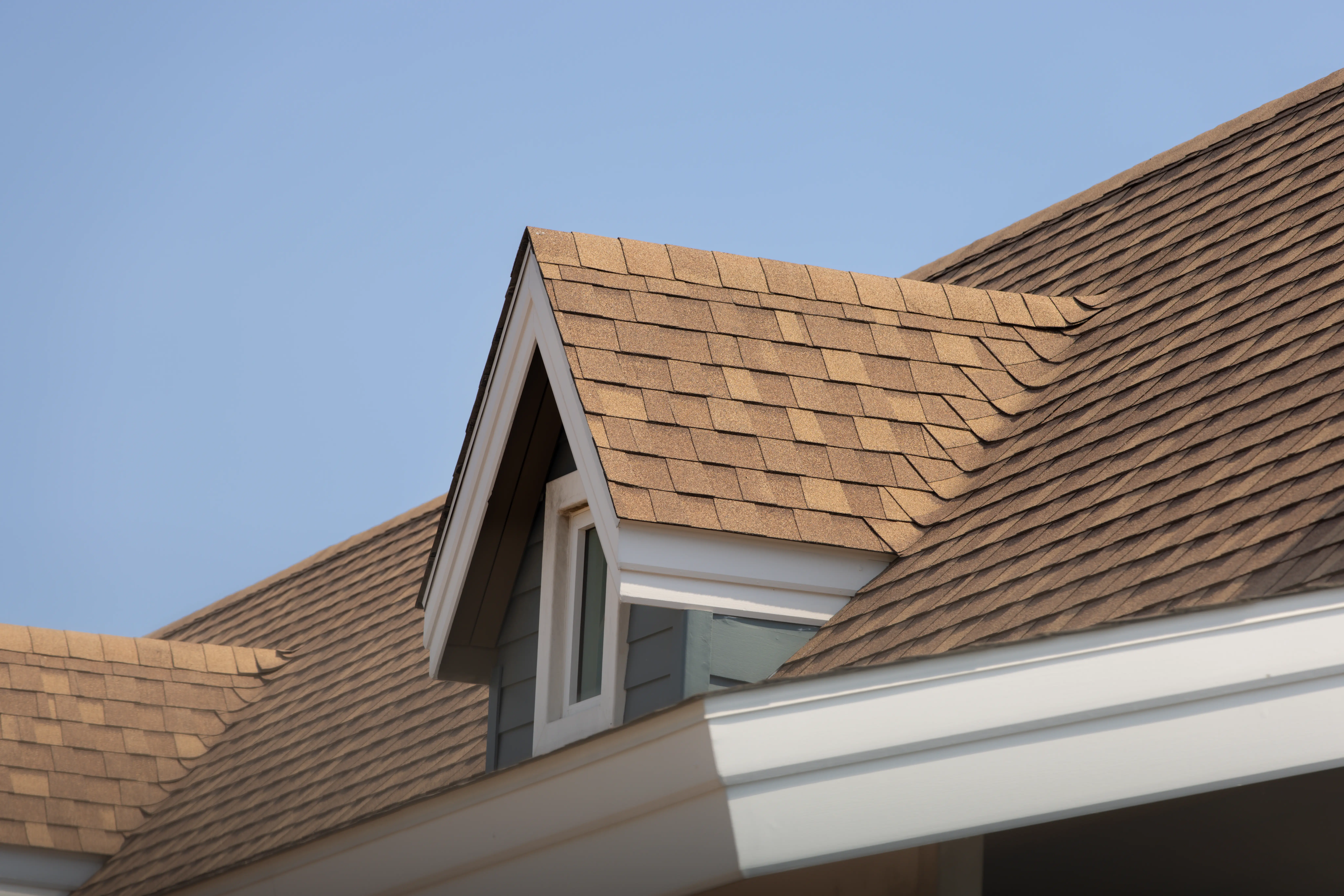 Image of a roof with brown shingles